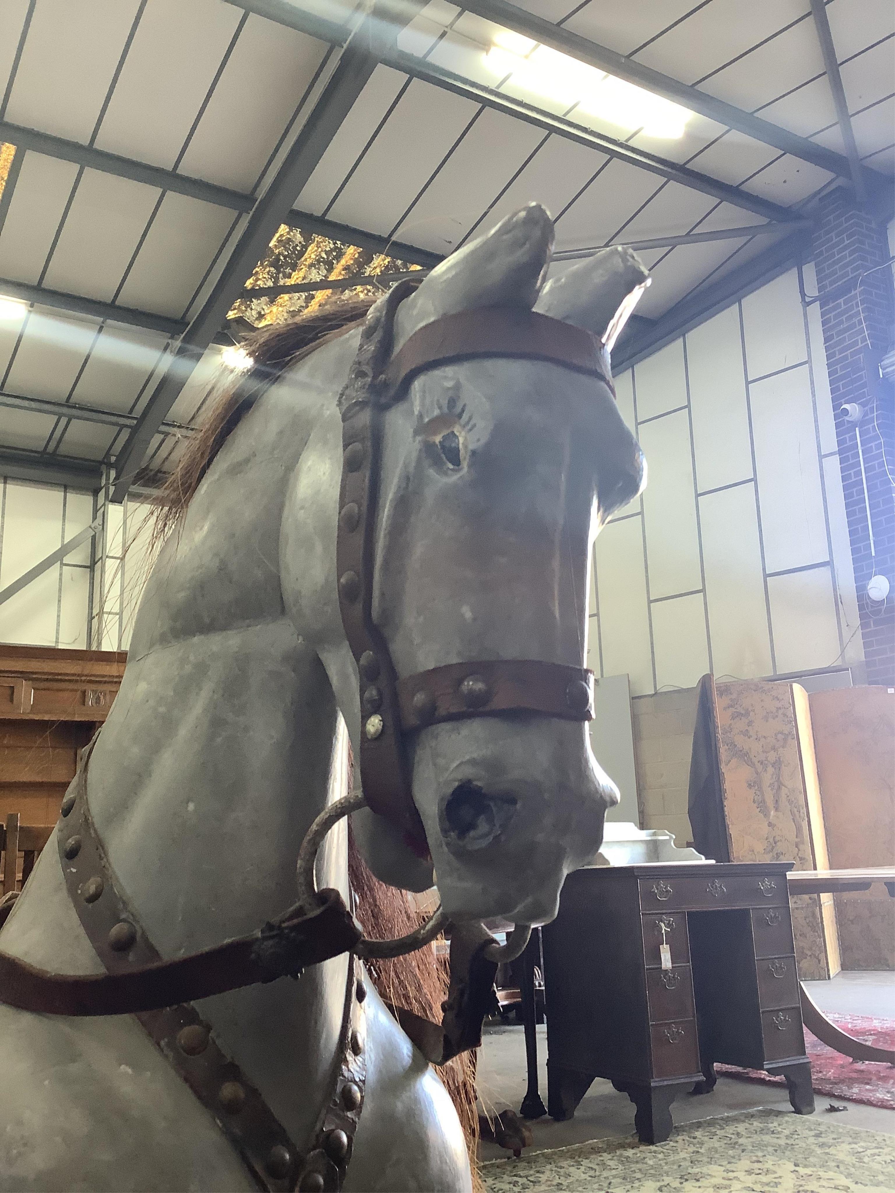 An early 20th century dapple grey rocking horse on pine safety frame, length 136cm, height 108cm. Condition - fair, later painted